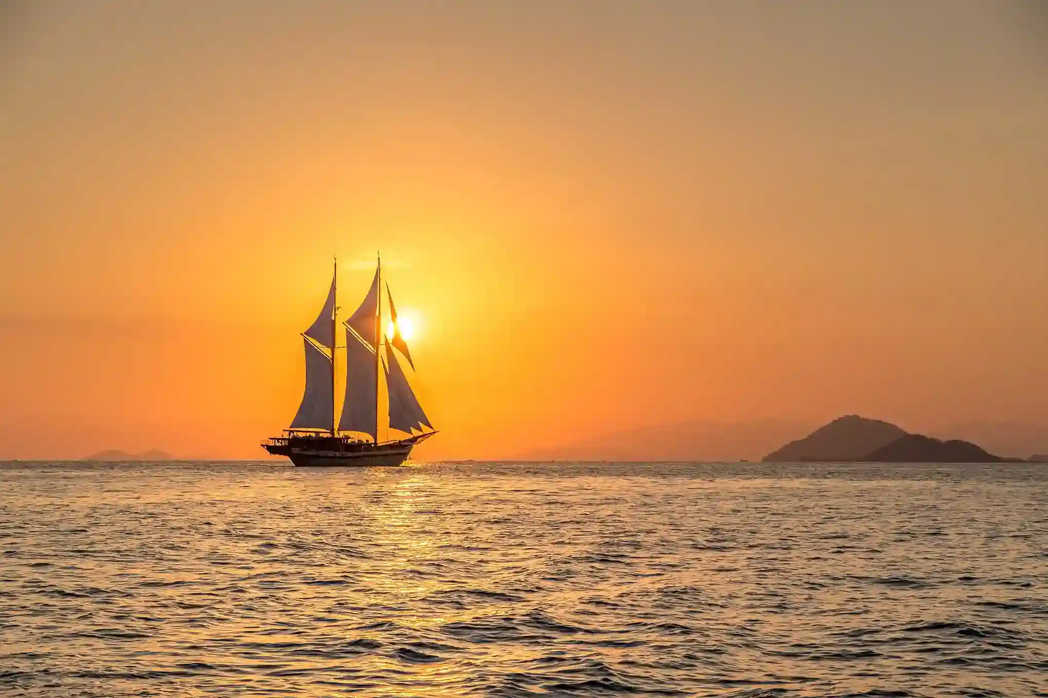 Phinisi under full sail in Komodo National Park